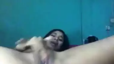 Desi female lies on back and wildly masturbates her XXX cherry on camera